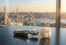 A photorealistic close-up of a complete dental implant, including a titanium screw and a white ceramic crown, resting on a clean surface. The background is a heavily blurred, out-of-focus view of a modern city in Turkey during a sunny day.