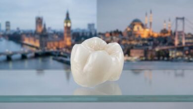 A close-up, photorealistic image of a perfect white dental crown, centrally focused. The background is softly blurred and split, with a UK landmark on one side and a Turkish landmark on the other, symbolizing the concept of dental tourism between the two countries.