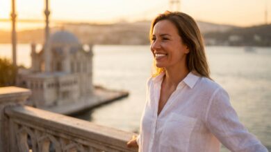 A close-up, photorealistic shot of a happy person with a brilliant white smile, with the sunny, blurred cityscape of Istanbul, Turkey in the background, symbolizing a successful dental tourism trip.