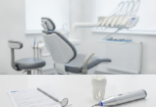 Conceptual image of two distinct choices in dentistry: one side shows simple documents and a basic dental tool, while the other displays a gleaming tooth model and an advanced dental instrument, all set on a white surface in a blurred modern dental clinic.