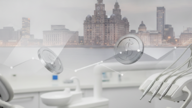 A soft focus image featuring the iconic Liver Building and Liverpool waterfront blurred in the background, with a clean, sterile dental clinic environment in the foreground. Abstract metallic shapes, resembling polished coins or geometric patterns, are subtly integrated, symbolizing the financial aspects of dental care.