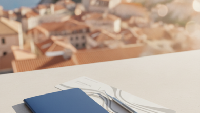 A detailed image showing a passport, a stylized boarding pass without text, and a modern dental tool resting on a clean surface, with a brightly lit, blurred European city background suggesting travel and dental care.
